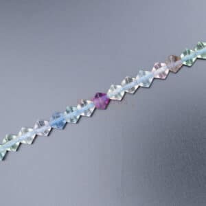 Fluorite bicone faceted colored approx. 6x6mm, 1 strand